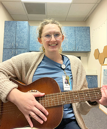 Photo of Emily Szillat with guitar